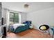 Cozy bedroom featuring warm wood floors, a comfy bed, and natural light from a window at 222 Laramie Dr, Stanley, NC 28164