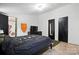 Relaxing bedroom with neutral walls, dark furniture, and two closets at 222 Laramie Dr, Stanley, NC 28164