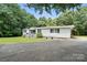 Exterior view showing the long driveway and single story home at 222 Laramie Dr, Stanley, NC 28164