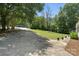 Long driveway with green lawn and manicured flowerpots at 222 Laramie Dr, Stanley, NC 28164