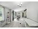 Bright, open-concept living and dining area with white walls and light gray wood flooring at 222 Laramie Dr, Stanley, NC 28164