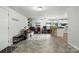 Open-concept living area with kitchen bar, neutral color palette, and tile flooring at 222 Laramie Dr, Stanley, NC 28164
