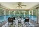 Cozy screened porch with wicker furniture and a ceiling fan, perfect for relaxing at 222 Laramie Dr, Stanley, NC 28164