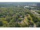 A panoramic view reveals the home nestled in a neighborhood surrounded by mature trees at 2680 Heavens Ct, Fort Mill, SC 29715