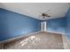 Spacious bedroom with blue walls, ceiling fan, and neutral carpet at 2680 Heavens Ct, Fort Mill, SC 29715