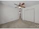 Spacious bedroom featuring a ceiling fan, closet, and doorway to an adjacent bathroom at 2680 Heavens Ct, Fort Mill, SC 29715