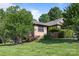 This property features a well-maintained lawn with mature trees and shrubbery, with a single-story home constructed with brick and wood at 2680 Heavens Ct, Fort Mill, SC 29715