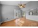 Bright living area with wood floors, ceiling fan, and large glass doors that open onto a private deck, blending indoor/outdoor living at 2680 Heavens Ct, Fort Mill, SC 29715