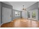 Open-concept living area with wood floors, a ceiling fan, and a door leading to a deck, enhancing natural light and accessibility at 2680 Heavens Ct, Fort Mill, SC 29715