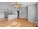 Open floor plan with wood floors leads from a spacious living area into the kitchen, creating an inviting, modern atmosphere at 2680 Heavens Ct, Fort Mill, SC 29715