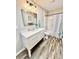 Modern bathroom featuring a sleek vanity, stylish mirror, and updated shower with unique patterned curtain at 287 Ben Eller Ln, Taylorsville, NC 28681