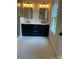 Modern bathroom with double vanity featuring marble counters, black fixtures, and stylish mirror at 3049 Reid Ave, Charlotte, NC 28208