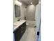 Modern bathroom with double vanity featuring marble counters, black fixtures, and stylish mirror at 3049 Reid Ave, Charlotte, NC 28208
