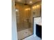 Modern bathroom featuring a glass enclosed shower with wood-style tile and brushed black fixtures at 3049 Reid Ave, Charlotte, NC 28208