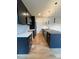 Modern kitchen featuring dark cabinets, stainless steel appliances, and a large island with stone countertop at 3049 Reid Ave, Charlotte, NC 28208