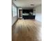 Bright open-concept living space with hardwood floors, modern lighting, and access to the kitchen at 3049 Reid Ave, Charlotte, NC 28208