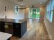 Bright open-concept living space with hardwood floors, modern lighting, and access to the backyard at 3049 Reid Ave, Charlotte, NC 28208