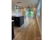 Bright open-concept living space with hardwood floors, modern lighting, and access to the backyard at 3049 Reid Ave, Charlotte, NC 28208