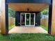 View of the open patio with modern ceiling fan and an open glass sliding door at 3049 Reid Ave, Charlotte, NC 28208