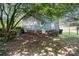 View of the home's backyard with trees and partial view of the home and stairs at 404 Community St, Rock Hill, SC 29730