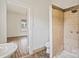 Bathroom featuring a tiled shower, white walls, and sink with entryway to another room at 404 Community St, Rock Hill, SC 29730