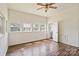 Bedroom featuring wood-look floors, large windows, and neutral walls, with entry to the bathroom at 404 Community St, Rock Hill, SC 29730