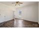 Bedroom with wood-look floors, white walls, ceiling fan, and windows overlooking the yard at 404 Community St, Rock Hill, SC 29730