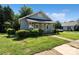 Charming single-story house featuring well-kept lawns, manicured shrubs, and a covered front porch at 404 Community St, Rock Hill, SC 29730