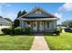 Charming single-story home with a covered front porch, green lawn, and mature landscaping at 404 Community St, Rock Hill, SC 29730
