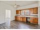 Kitchen with wood cabinetry, double sink, and ceiling fan at 404 Community St, Rock Hill, SC 29730