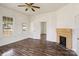 Living room with wood-look floors, white walls, a fireplace, and natural light from the window at 404 Community St, Rock Hill, SC 29730