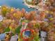 Aerial view of a home surrounded by trees in peak autumn colors near the water at 480 Robinson Rd, Mooresville, NC 28117