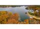 Scenic lake view with colorful autumn trees and lakeside properties in the background at 480 Robinson Rd, Mooresville, NC 28117