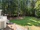 Lush backyard with a well-maintained lawn, mature trees, and a stone pathway at 480 Robinson Rd, Mooresville, NC 28117