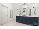 Bathroom with a blue vanity, double sinks, and large mirrors at 480 Robinson Rd, Mooresville, NC 28117