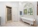 A bright bathroom with a clawfoot tub, tile floor, and glass shower at 480 Robinson Rd, Mooresville, NC 28117