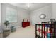 Bright bedroom features a ceiling fan, natural light, and a red chest of drawers at 480 Robinson Rd, Mooresville, NC 28117