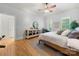 A bedroom with a ceiling fan, hardwood floors, and a wooden dresser at 480 Robinson Rd, Mooresville, NC 28117