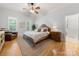 This bedroom has hardwood floors, a ceiling fan, and a brown leather chair at 480 Robinson Rd, Mooresville, NC 28117