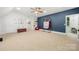 Bright bonus room features a blue accent wall and a variety of spaces for children to play and explore at 480 Robinson Rd, Mooresville, NC 28117