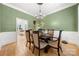 Dining room with green walls, hardwood floors, and an elegant table setting at 480 Robinson Rd, Mooresville, NC 28117