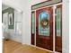 Elegant foyer showcasing a beautiful wooden front door with stained glass, complemented by hardwood floors and detailed trim at 480 Robinson Rd, Mooresville, NC 28117