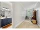 Hallway leading to a bathroom featuring a window and carpeted flooring at 480 Robinson Rd, Mooresville, NC 28117