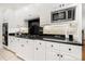 Modern kitchen features black countertops and white cabinetry with stainless appliances at 480 Robinson Rd, Mooresville, NC 28117