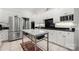 Stylish white kitchen featuring stainless steel appliances and a marble island at 480 Robinson Rd, Mooresville, NC 28117