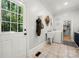 Functional laundry room with utility sink, washer, dryer, and access to the outdoors via a glass paneled door at 480 Robinson Rd, Mooresville, NC 28117