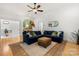 Open-concept living room with a comfortable blue sectional, hardwood floors, and an inviting archway at 480 Robinson Rd, Mooresville, NC 28117