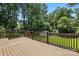 Spacious back deck with wood railing overlooking the backyard and lush greenery at 5126 Unaka Ave, Charlotte, NC 28205