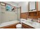 Bathroom featuring shower-tub combo and decorative wood vanity at 5126 Unaka Ave, Charlotte, NC 28205