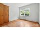 Well-lit bedroom featuring hardwood floors and a large window with tree views at 5126 Unaka Ave, Charlotte, NC 28205